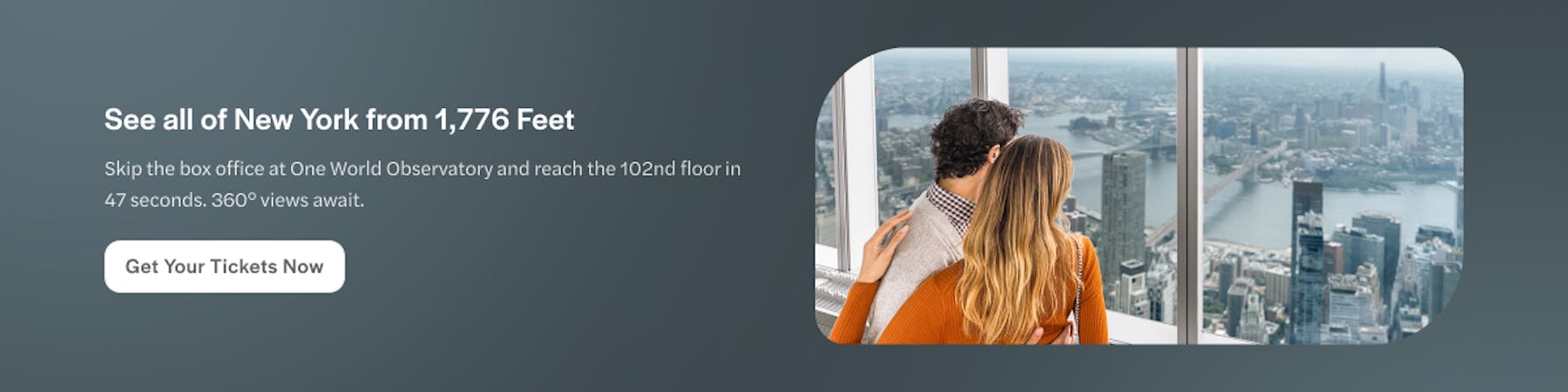 Couple enjoying panoramic views of New York City skyline from One World Observatory.